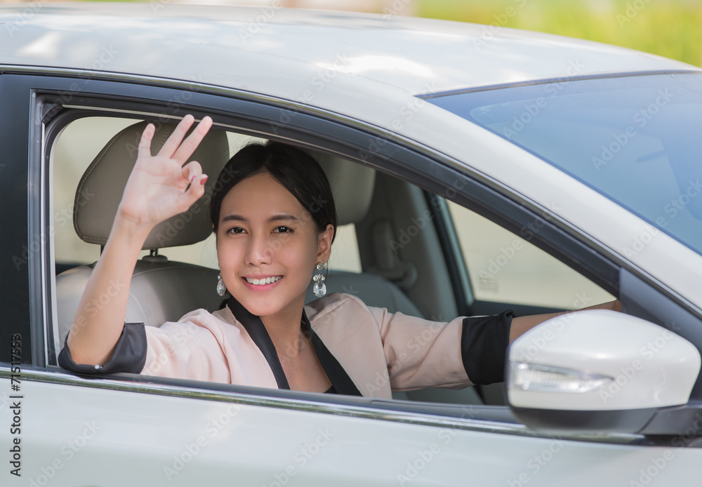 Smiling happy young woman in the car