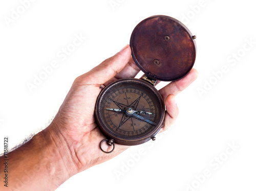 Geographical compass in male hand
