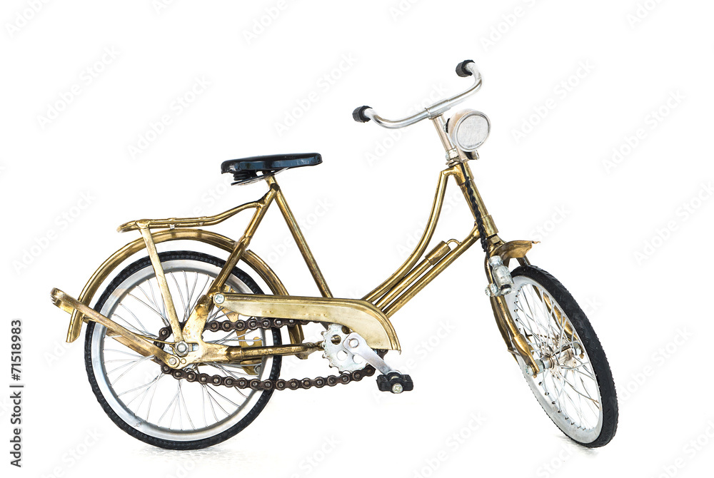 Fototapeta premium Small gold color toy bicycle