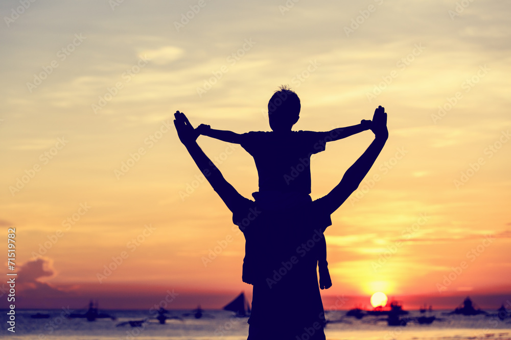 happy father and son on sunset beach