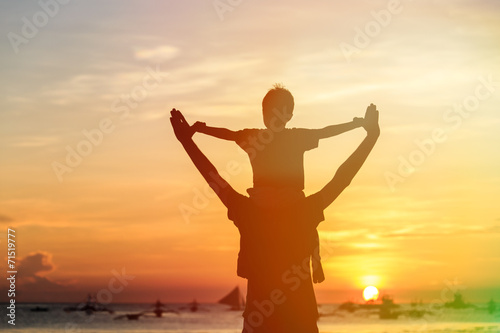 happy father and son on sunset beach