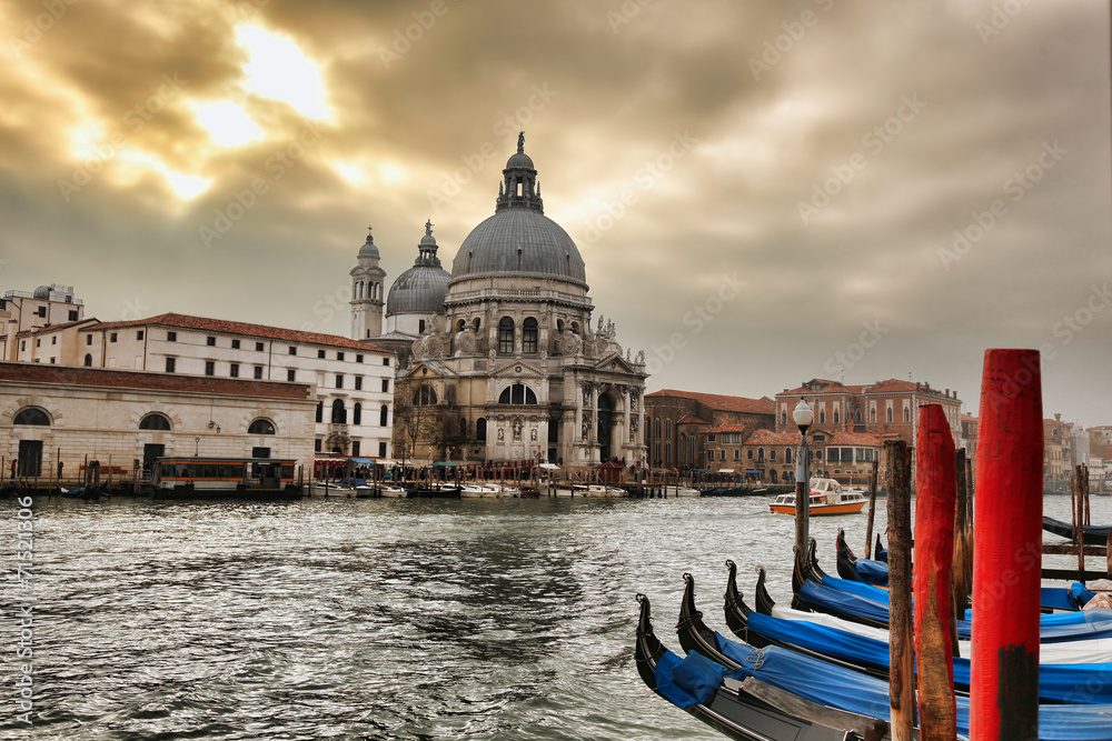 Venice with gondolas against sunset in Italy