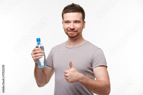 man in jeans and a T-shirt with bottle of water