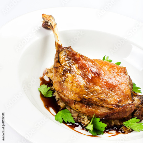 Roasted chicken seasoned with fresh herbs in a white plate macro