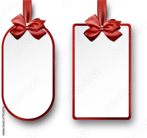 White paper gift cards with red satin bows.