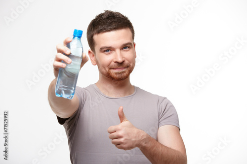 man in jeans and a T-shirt with bottle of water