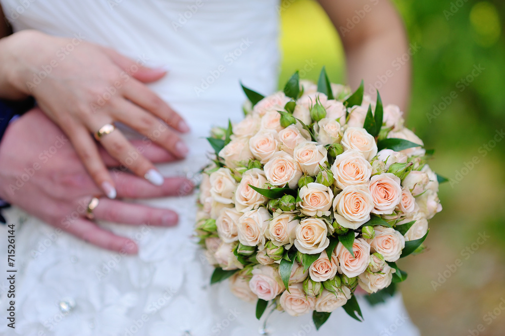 the bride holding wedding bouquet of pink and white roses the bride holding wedding bouquet of pink and white roses