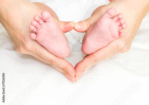 Baby's feet in mother's hand © TravelWorld