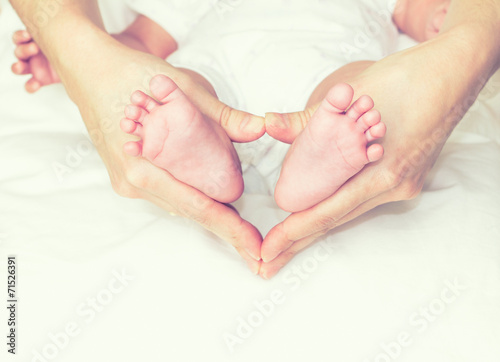 Mother holding the baby's feet