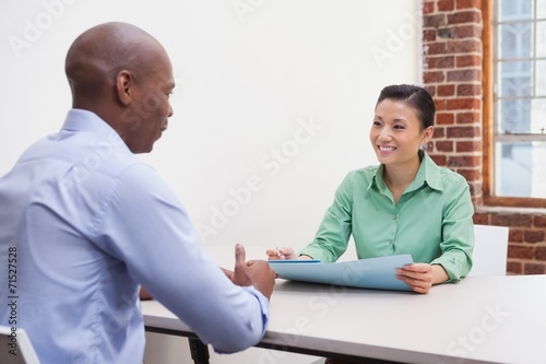 Casual business people talking at desk