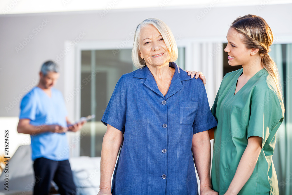 Senior Woman Being Assisted By Female Caretaker In Nursing Home Senior Woman Being Assisted By Female Caretaker In Nursing Home