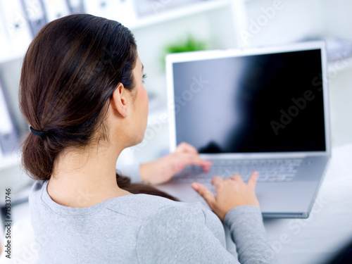 Back view of woman on her laptop
