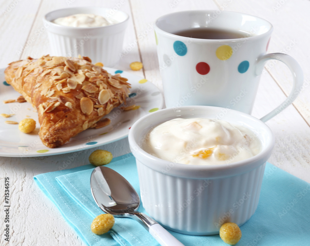 Delicious breakfast: yogurt, bun and tea Delicious breakfast: yogurt, bun and tea
