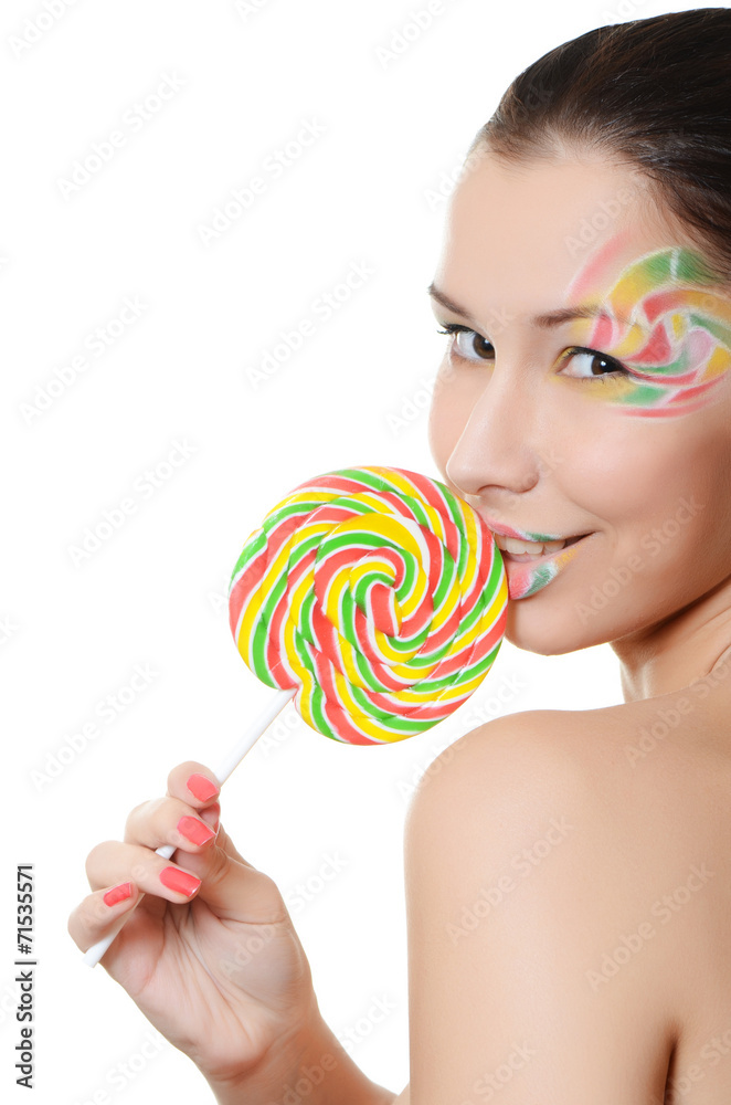 The girl with a sugar candy isolated on white