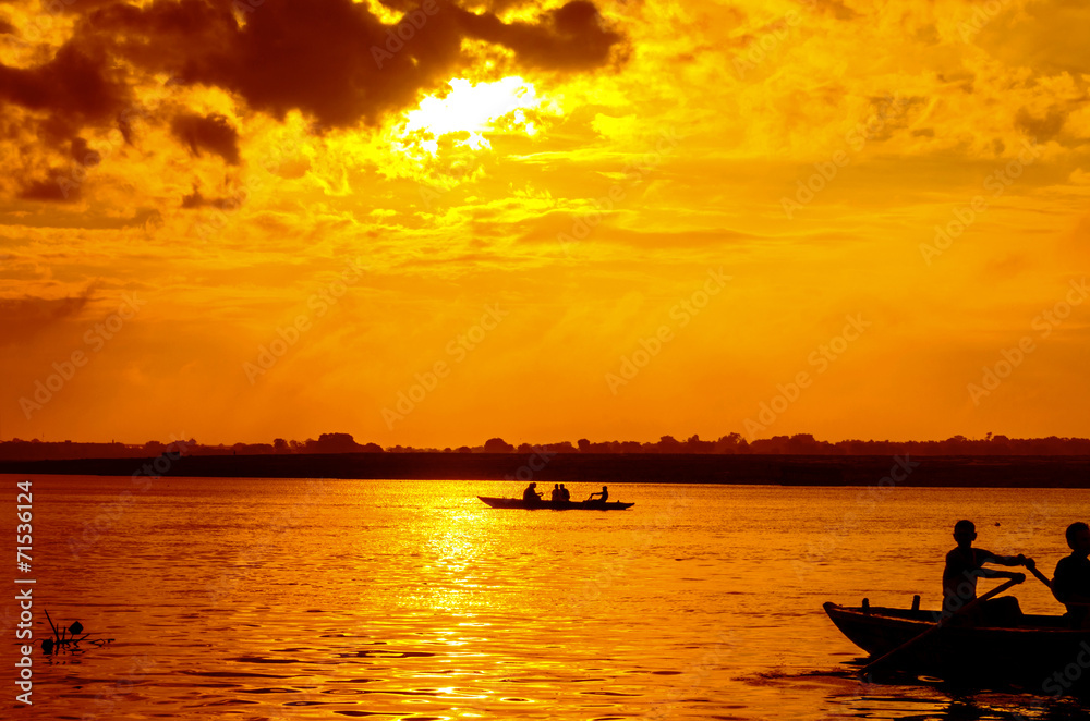 boat sailors at sunrise sunset