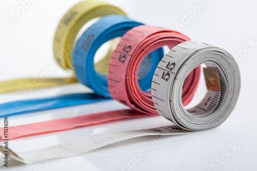 four rolls of colorful measuring tapes