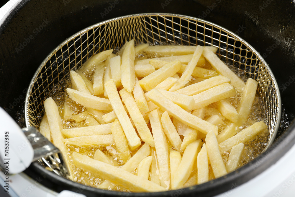 French fries in deep fryer, closeup French fries in deep fryer, closeup