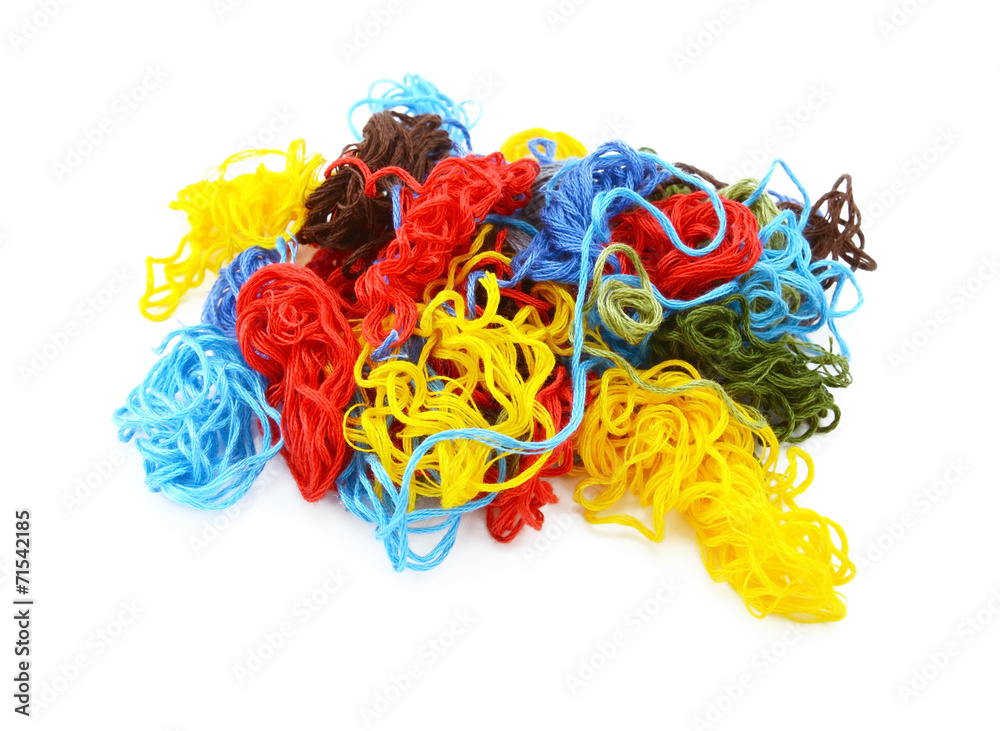 Multi-coloured embroidery threads in a tangled heap