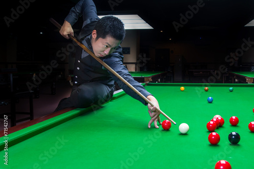Handsome man playing snooker photo