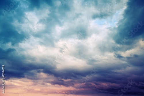 Dark blue stormy cloudy sky natural photo background, toned