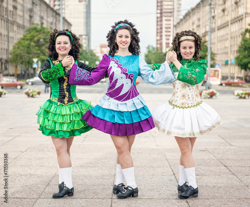Three women in irish dance dresses posing