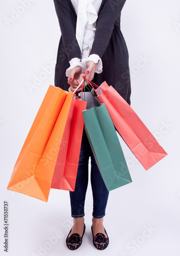 Portrait of a blond woman with shopping bags in a studio