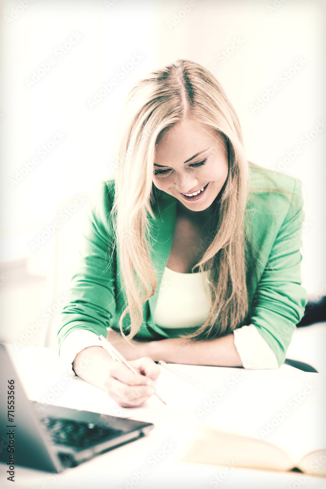smiling student girl writing in notebook smiling student girl writing in notebook