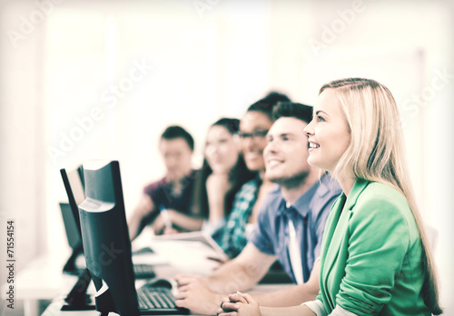 students with computers studying at school