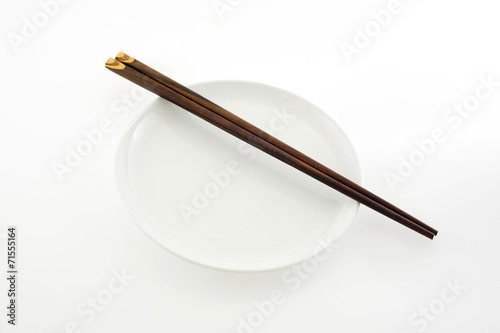 white plate with chopsticks isolated on white background