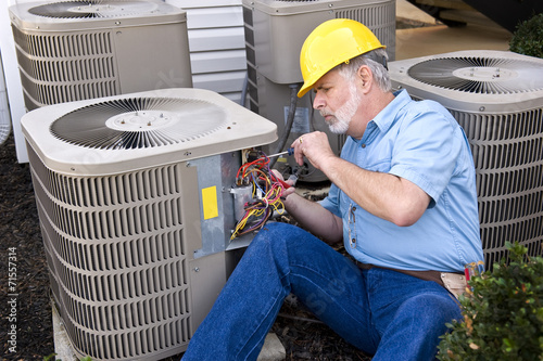 Middle-aged Air Conditioning Repairman At Work