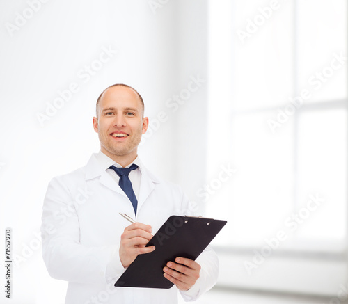 smiling male doctor with clipboard
