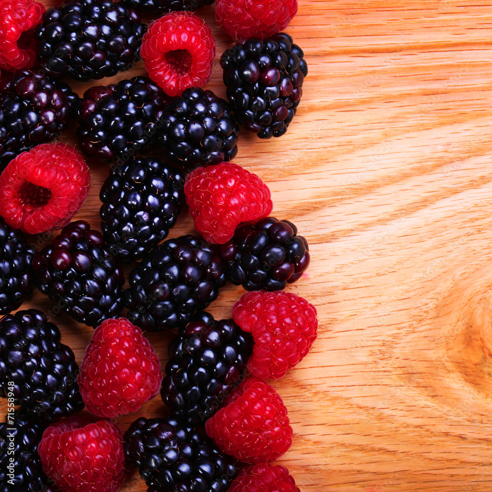 Raspberries and Blackberry on Wooden Background Raspberries and Blackberry on Wooden Background