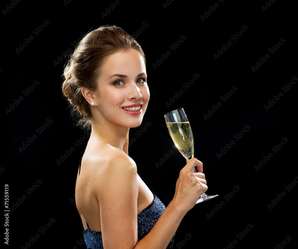 smiling woman holding glass of sparkling wine smiling woman holding glass of sparkling wine