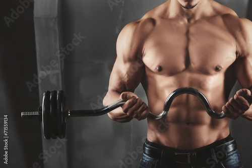 Close up of young muscular man lifting weights #71559134