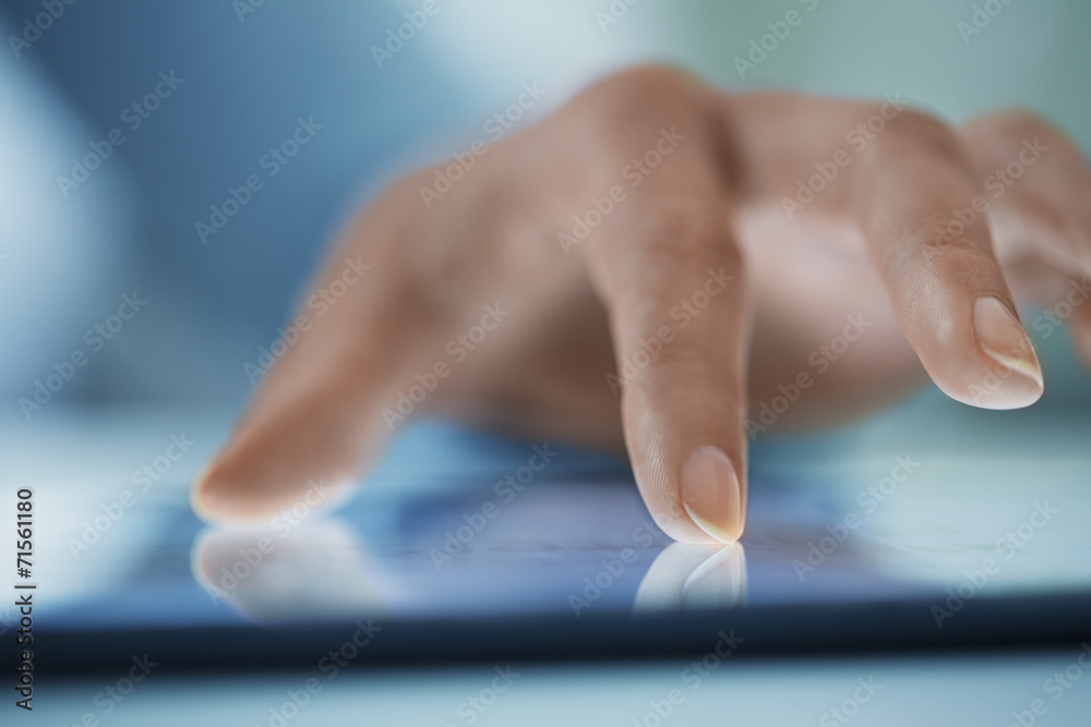 Woman using tablet pc, close-up on fingers Woman using tablet pc, close-up on fingers