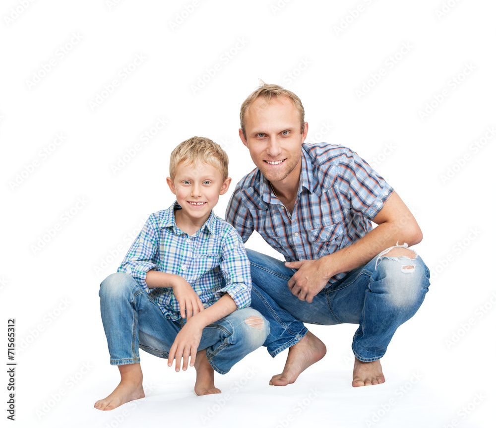 Father with son dressed in jeans and plaid shirts on the white Father with son dressed in jeans and plaid shirts on the white