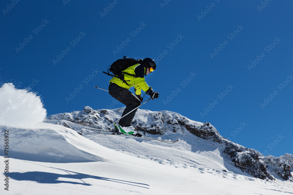 Alpine skier jumping from hill
