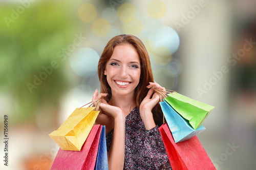 Shopping concept. Beautiful young woman with shopping bags