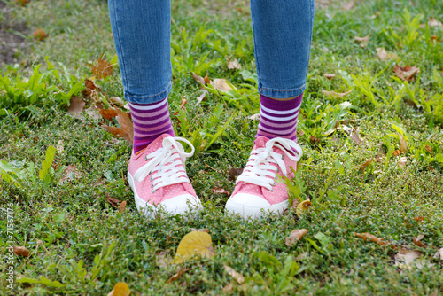 Female legs in colorful socks and sneakers outdoors © Africa Studio