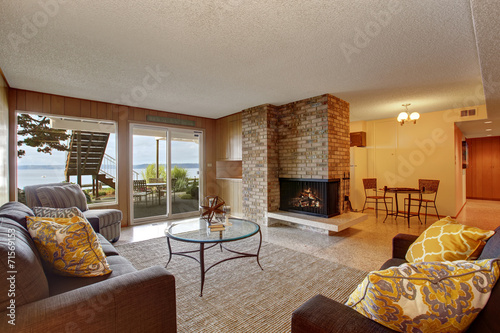 Basement living room with fireplace and walkout patio photo