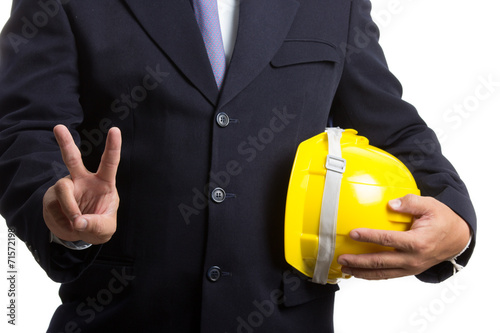 Engineer holding safety hat and show V win sign