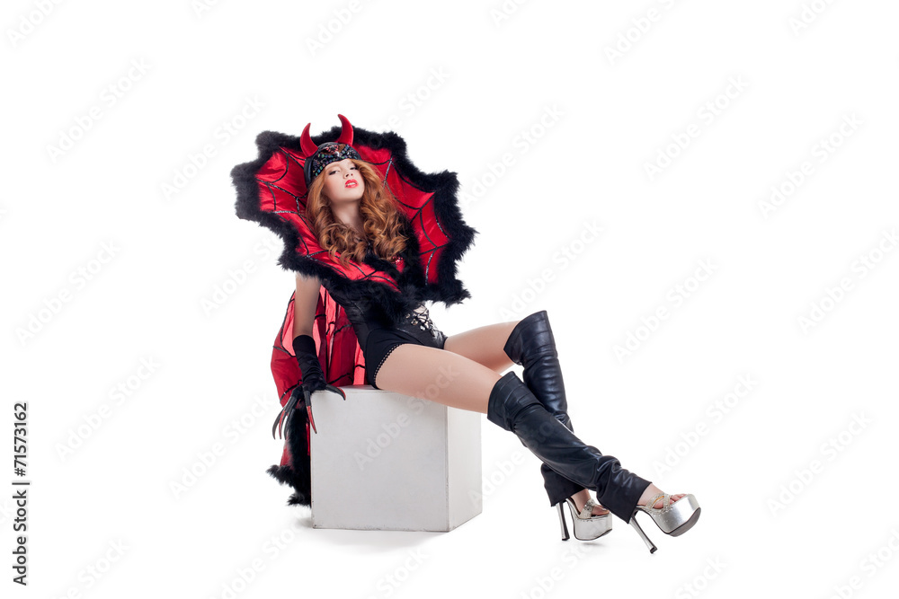 Young confident woman posing dressed as devil