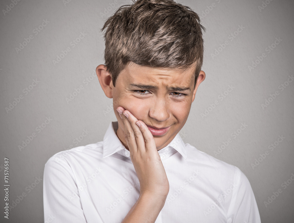 Headshot young man with sensitive tooth ache grey background Headshot young man with sensitive tooth ache grey background