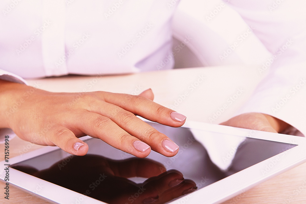 Woman using digital tablet on light background Woman using digital tablet on light background