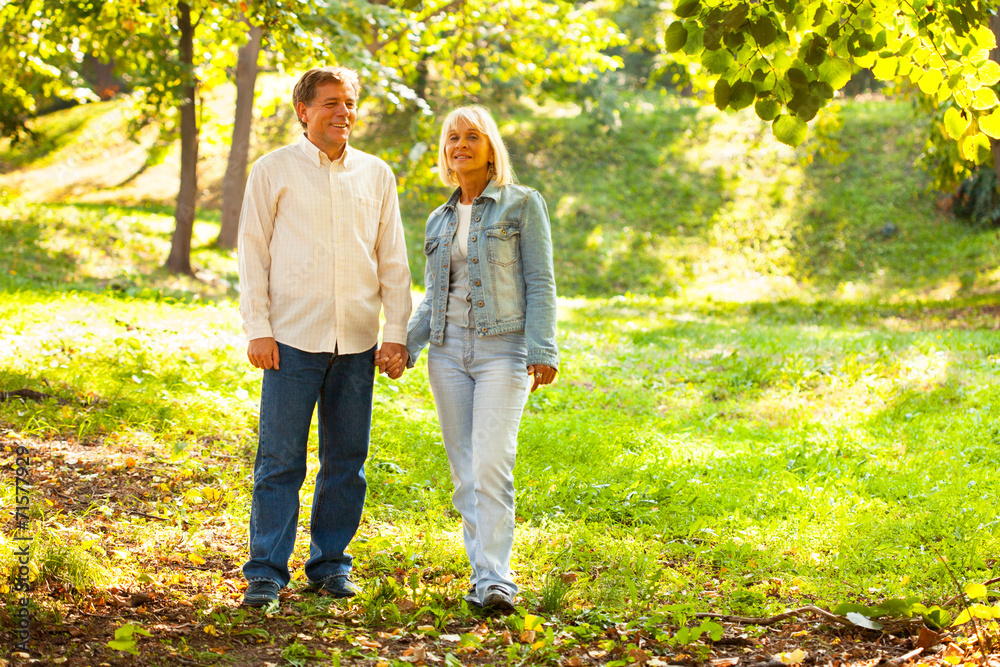 Fototapeta premium Mature couple walking in the autumn park