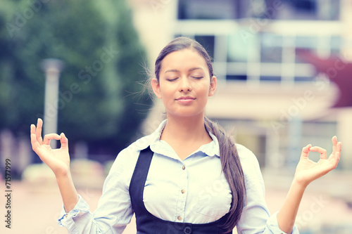 woman meditating outdoors outside cop orate office 