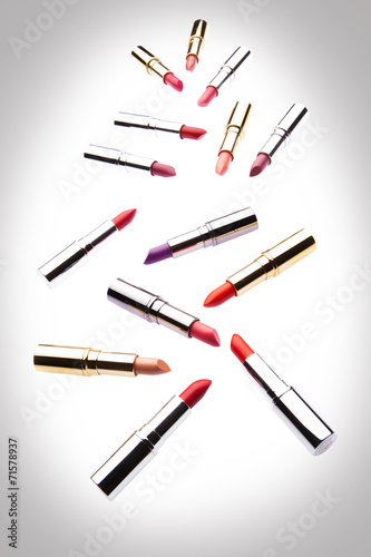 Different-colored lipsticks on white background
