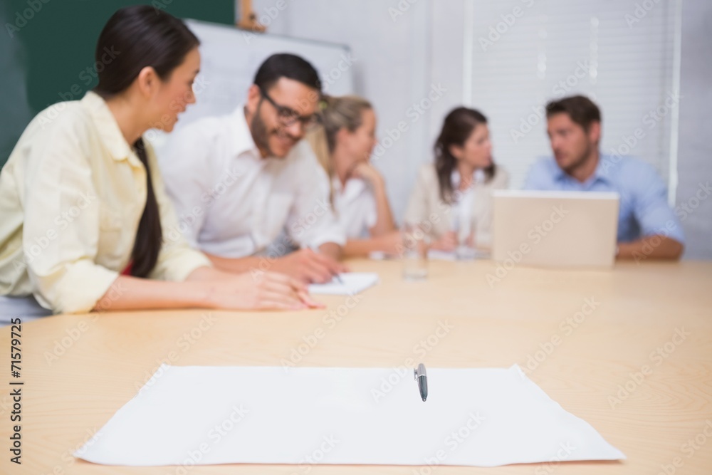 Blank page on the table in front of the business team Blank page on the table in front of the business team