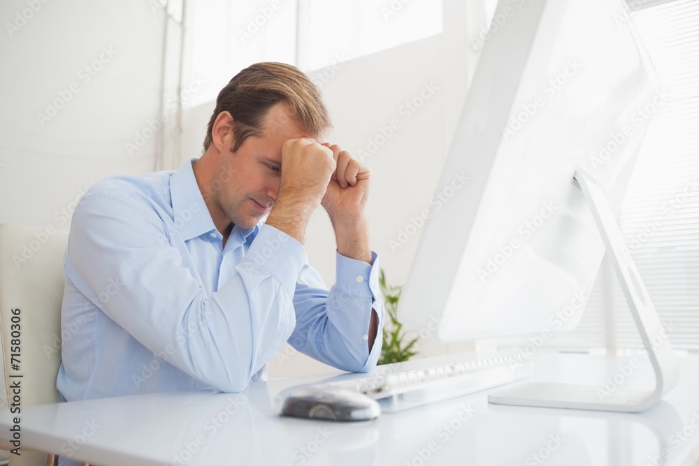 Stressed businessman sitting at his desk Stressed businessman sitting at his desk