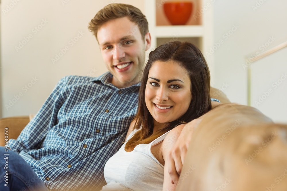 Happy young couple relaxing on the couch Happy young couple relaxing on the couch